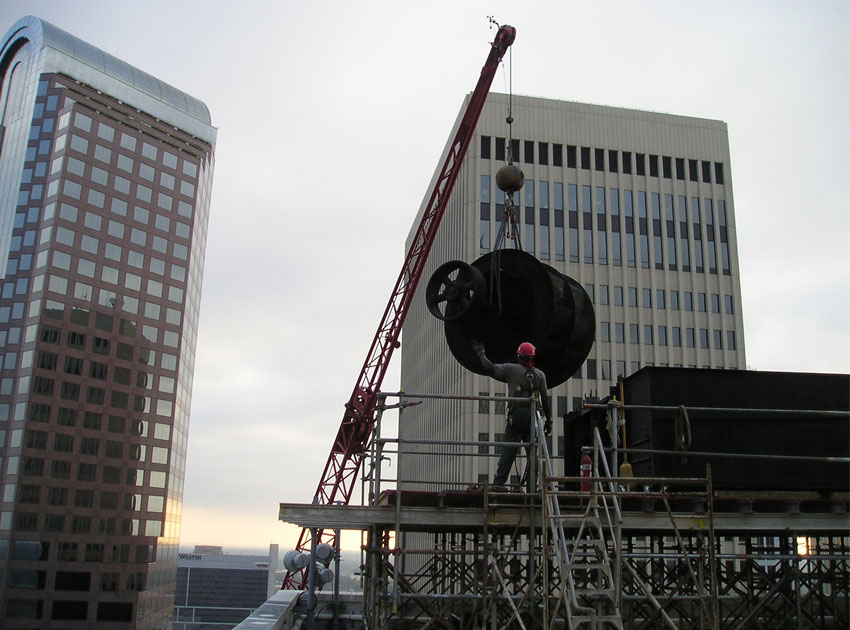 Our rigging team lifts a fan assembly atop a 240-foot tower.